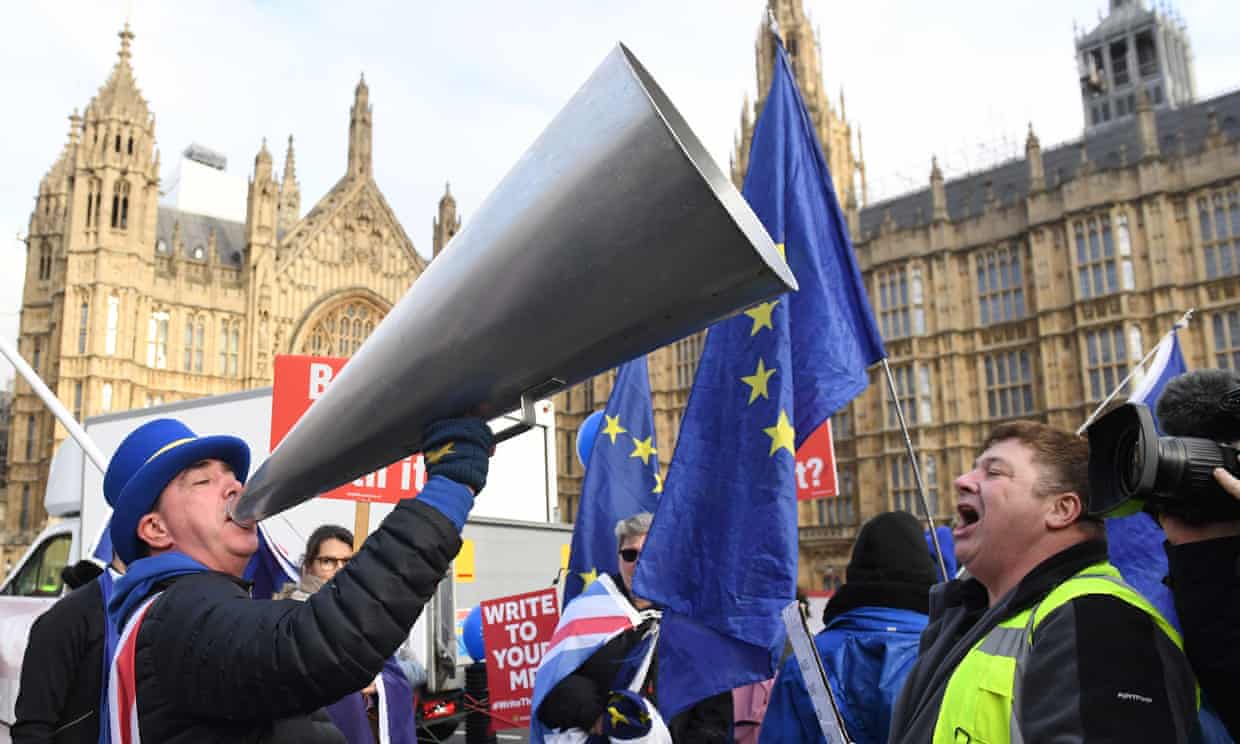 Pro and anti-Brexit protesters outside Westminster shout at each other.
