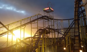Rollercoaster ride, at sunset, at Barry’s Amusements, Portrush, Northern Ireland.