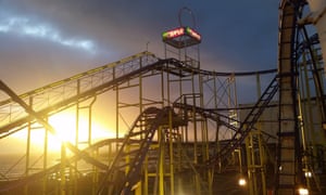 Rollercoaster ride, at sunset, at Barry’s Amusements, Portrush, Northern Ireland.