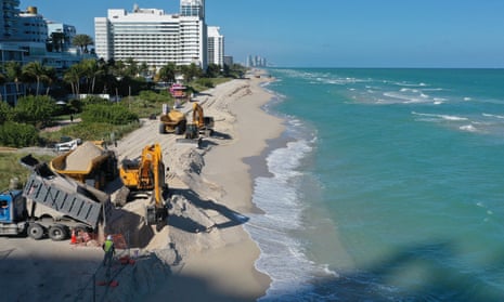 The US Army Corps of Engineers distributes sand along the beach in Miami Beach, Florida. The project is part of a $16m scheme to widen the beaches in an effort to fight erosion and protect properties from storm surges.