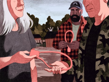 A woman hands a cable gun lock to a man