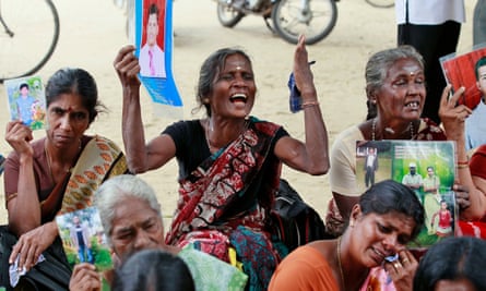 Tamil women hold portraits of their missing relatives during a protest in Jaffna, Sri Lanka, in November 2013 during a visit by British PM David Cameron.