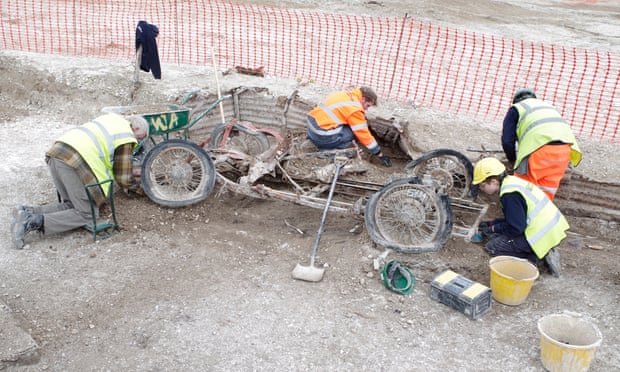 Archaeologists with the remains of a red MG sports car found at Larkhill.