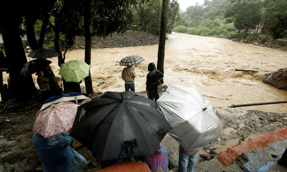 People look at the Tiribi river flooded after heavy rains by Tropical Storm Nate in San Jose, Costa Rica October 5, 2017. REUTERS/Juan Carlos Ulate