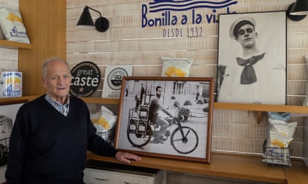 César Bonilla with photographs capturing the brand’s history