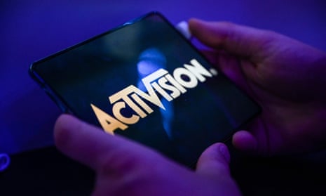 A visitor plays the game 'Call of Duty' of Activision on a mobile phone at the Samsung mobile booth at the Gamescom video game fair in Cologne on August 24, 2022.