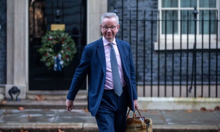 Michael Gove leaving Downing Street, smiling, with a brown leather satchel