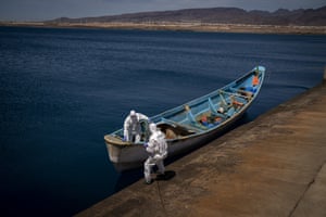 Police officers inspect a boat where 15 Malians were found dead adrift in the Atlantic in Gran Canaria island, Spain, 19 August