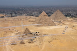 Giza, Egypt. A joint flight of South Korean and Egyptian aerobatic teams fly past the Pyramids