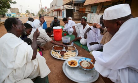Sudanese men break their fast in a street in the capital Khartoum
