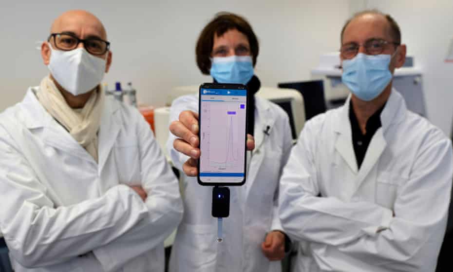 University of Lille researchers Rabah Boukherroub, Sabine Szunerits and David Devos with a smartphone showing CorDial-1 test result.