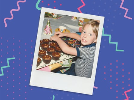 An old photo of a young boy with lots of cupcakes on the table in front of him at a birthday party
