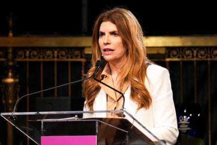 A woman speaks into a microphone.