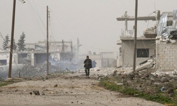 Syrian government forces walk in Deir al-Adas in the Daraa province.