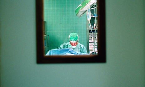 A surgeon operating on someone