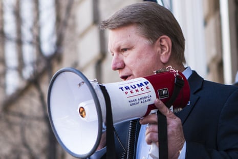 Jim Marchant holds a bullhorn emblazoned with "Trump/Pence: Make America Great Again".