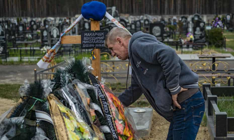 A man visits the grave of his soldier relative in the northern city of Slavutych, home of most of the workers in the Chernobyl nuclear plant