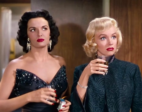 Russell and Monroe looking surprised, drinks in hand, heavily made up and glamorous