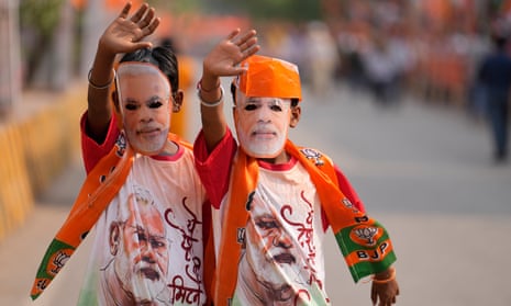 Supporters of Bharatiya Janata Party(BJP) wear masks in the likeness of Indian Prime Minister Narendra Modi during a roadshow by Modi in Varanasi, India.
