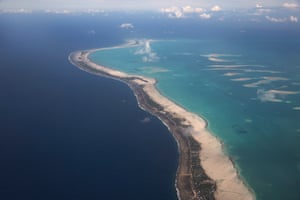 The island of South Tarawa, looking south towards the most heavily populated areas of Bairiki and Betio. The ocean side is to the left and the lagoon side is to the right.