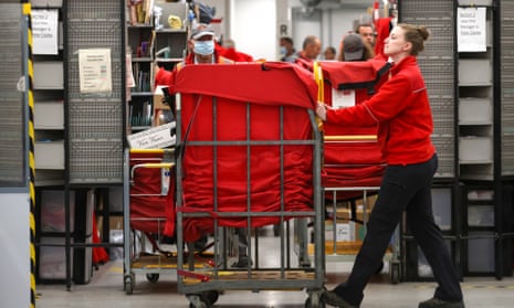 Royal Mail worker pushing trolley in sorting office