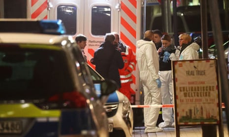 Forensic experts are seen outside a shisha bar after a shooting in Hanau near Frankfurt, Germany.