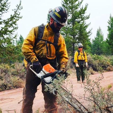 A firefighter using a chainsaw.
