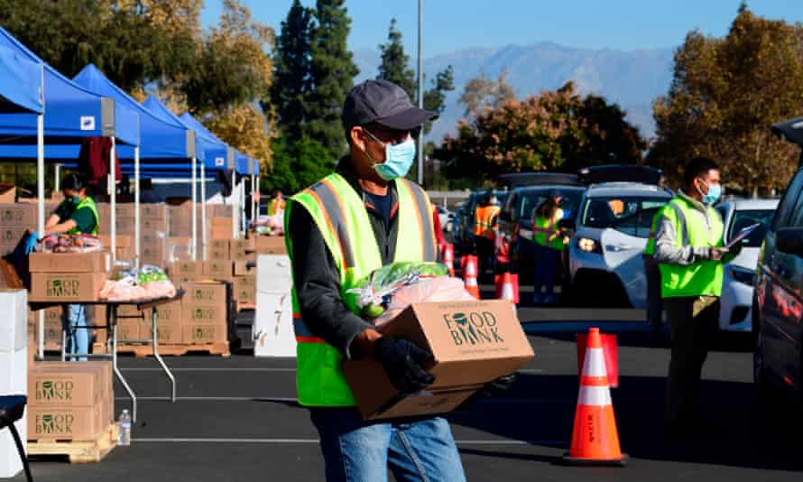 Drivers wait for food distribution from the Los Angeles Food Bank on 4 December 2020 in Hacienda Heights, California.
