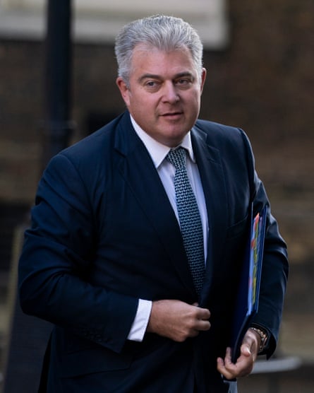 Brandon Lewis in the street carrying a document case under his arm