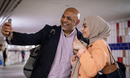 Leanne Mohamad poses for a selfie with a man in a suit