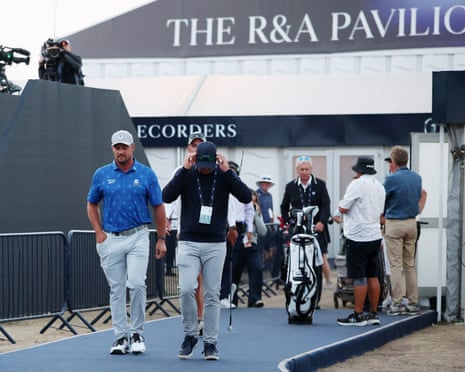 Bryson DeChambeau (left) departs scoring after being handed a two-shot penalty.