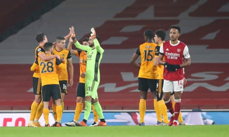 A dejected Pierre-Emerick Aubameyang as Wolves players celebrate victory