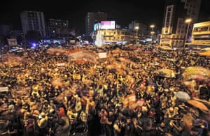 Protesters waving national flags at al-Nour Square in Lebanon’s northern city of Tripoli