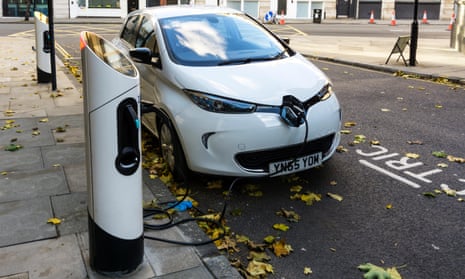 White Renault Zoe Dynamique NAV electric car charging at kerbside charging point
