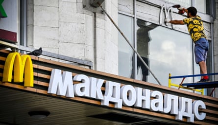 A worker removes McDonald’s logo from a restaurant in Moscow in June 2022.