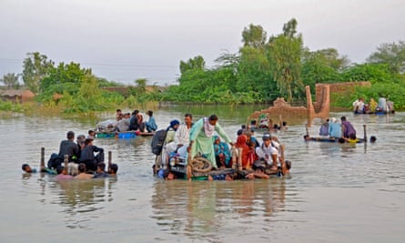 People wading through flood water
