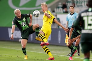 Wolfsburg’s Xaver Schlager (left) vies for the ball with Dortmund’s Erling Haaland.