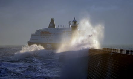 A ferry on rough seas with a pier in the foreground