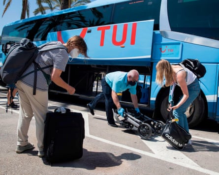 Tourists prepare to board at bus of the tour operator TUI upon their arrival at the in Palma de Mallorca