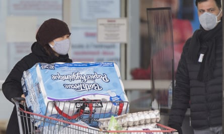 A woman wearing a mask leaves a Costco store in Montreal last month.