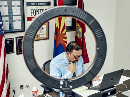 Seated man adjusting his suit in