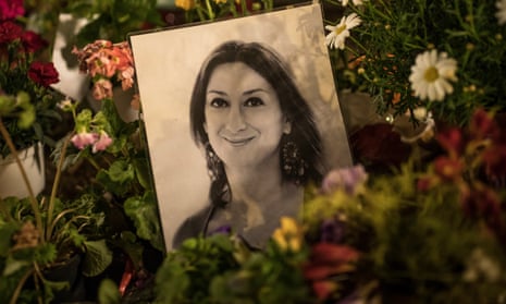 A photo of Daphne Caruana Galizia sits among floral tributes to the murdered journalist.