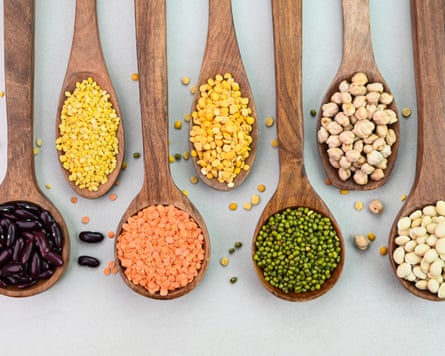 Variety of lentils and pulses on a white background.