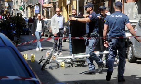 Italian police work on the site where mafia boss Giuseppe Dainotti, 67, was gunned down by two killers while riding his bike on Monday in Palermo, Sicily.