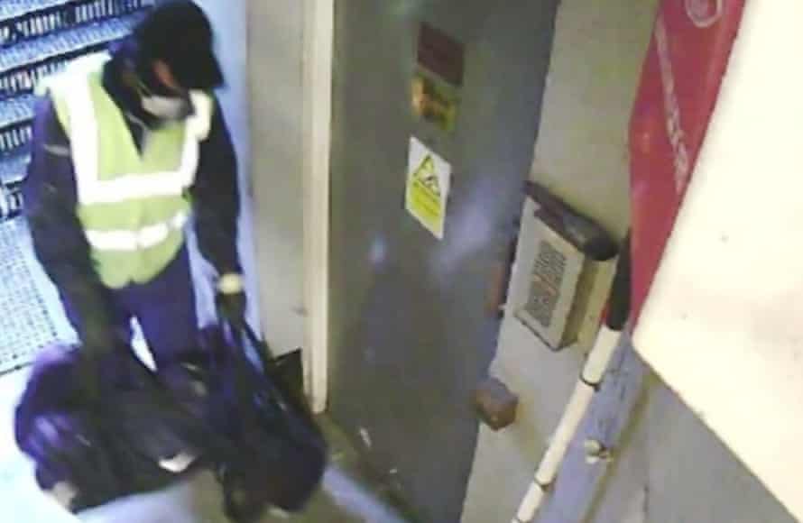 A still image taken from CCTV footage showing one of the burglars carrying tools in the fire escape corridor