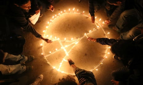 Hands reach into circle to light candles in an image of the Eiffel tower