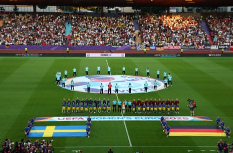 Teams line up with young mascots during the national anthems.