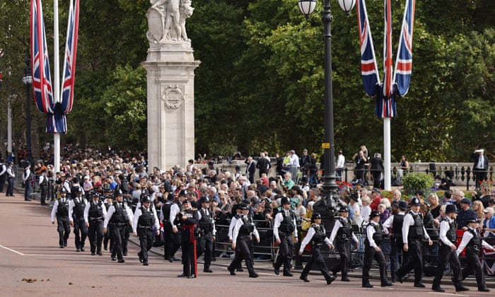 Police officers march along The Mall ahead of the procession to carry the body of Britain’s late Queen Elizabeth II from Buckingham Palace to Westminster Hall.