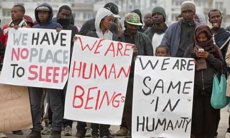 Refugees seeking to travel to the UK demonstrate in the centre of Calais