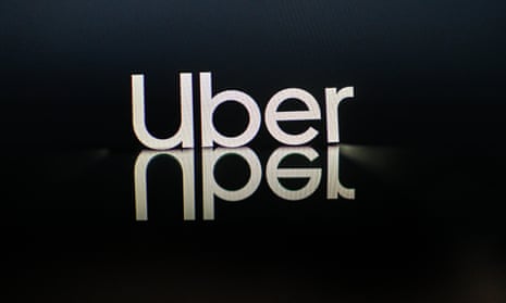 White Uber logo mirrored on black reflective surface